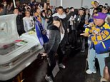 Outrageous moment widow TWERKS against her late husband's open coffin during his funeral
