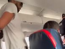 Petrifying moment man tries to open Delta plane's door in mid-air as he fights with the flight crew