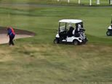 Fake America Great Again?! Moment Trump's golf caddy appears to surreptitiously drop ball in prize spot before president takes shot