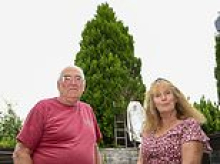 Couple finally win battle over neighbours' huge untrimmed hedge that left them suffering 'five years without sunshine'