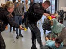 Police officer punched six times by thug in Manchester Airport brawl could still face being sacked