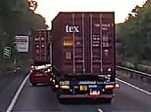 Moment reckless driver attempts dangerous overtake of huge lorry on motorway before being dramatically WIPED OUT in the middle of the road