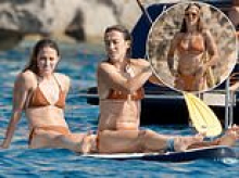 Lioness Lucy and her defeated Euros opponent have a ball... in matching her-and-hers bikinis