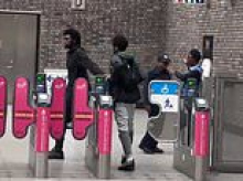 Moment staff on London's 'lawless' Tube appear to ignore two fare dodgers who shamelessly push their way through barriers next to where they are standing