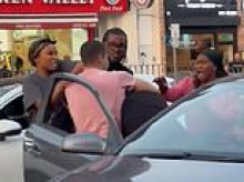 Moment 'road rage' row explodes into violence in broad daylight as woman is put into a headlock during melee