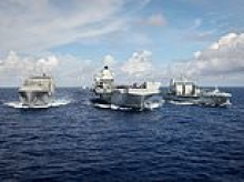Royal Navy flexes its military muscles in show of strength to China as HMS Prince of Wales joins fleet of warships from US, Japan and Australia in northern Philippine Sea