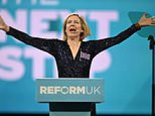 Moment Dame Andrea Jenkyns makes rock star entrance to Reform UK conference in a blue sparkly jumpsuit singing 'I'm an insomniac' song she co-wrote