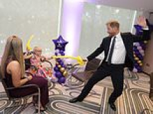 Prince Harry sword fights with children at WellChild awards after paying visit to late Queen's grave in Windsor while William and Kate were at official engagement just seven miles away