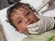 Stomach-churning moment doctor pulls a CRAB out of a boy's ear after he felt something wriggling in his head following trip to the beach