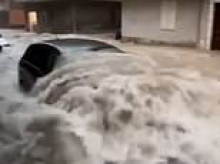 Freak storm triggers severe flooding in Italian holiday hotspot as roads turn into raging rivers and woman is swept away