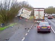 Moment lorry ploughs into layby and crashes into parked cars leaving two people seriously hurt - as woman, 35, admits dangerous driving