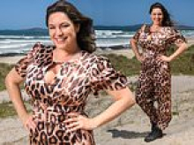 Kelly Brook injects a dose of glamour to the I'm A Celeb jungle camp as she parachutes onto the beach wearing a leopard-print cleavage-baring jumpsuit