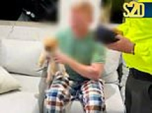 Moment two 'members of Irish mafia wanted in Britain' are arrested by heavily-armed Colombian cops - with one pyjama-clad suspect clutching his pet Pomeranian