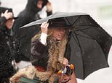 Storm Claudia tears down trees, floods towns and threatens second day of Cheltenham racing meet as it dumps a month's worth of rain on Britain