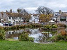 Woke council accused of 'levelling down' one of Britain's prettiest villages over plans to buy up quaint homes for temporary housing