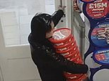 Moment brazen shoplifter dubbed the 'Bounty Hunter' is caught on CCTV stealing eight tubs of Celebrations