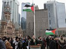 Fury as Palestinian flag is raised at Toronto's city hall as police turn on man singing CANADIAN national anthem