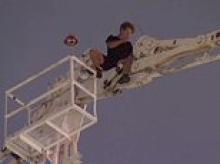 Teenager causes chaos in busy CBD after climbing a 70-metre high crane and refusing to come down for hours