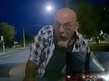 Aussie motorcyclist's wild road-rage rampage backfires after he leaps onto a moving car and hangs on for kilometres