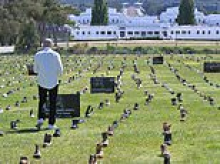 Why thousands of men's boots have have been placed outside Parliament House in Canberra