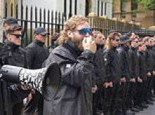 Neo-Nazi who led rally outside NSW parliament is arrested in Bondi by federal police - after another had their visa torn up