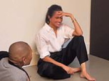 Blushing Meghan throws a coy look as she's congraulated for being a '10 out of 10' behind the scenes of Harper's Bazaar shoot