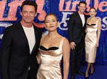 Kate Hudson sets pulses racing in a plunging corset gown as she cosies up to co-star Hugh Jackman at premiere of their film Song Sung Blue in Paris
