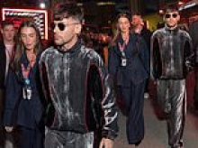 Louis Tomlinson wears a shiny velour tracksuit as he makes a rare public appearance with Zara McDermott at the Las Vegas Grand Prix