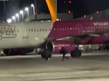Late passengers chase their plane on the runway after missing the flight... and are arrested by German police