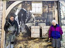 Meet the artist behind 'Muriel's garden': Painter who gave flower-loving great-grandmother 'dream' artwork on side of house has transformed famous town with his fantasy landscapes