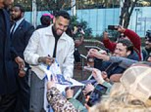 Chris Brown appears in court over alleged tequila bottle attack on music promoter at London nightclub - before signing autographs for fans as he leaves hearing