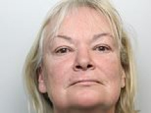 Woman who slept next to her partner's dead body for three weeks after he died of a heart attack is jailed for preventing a lawful and decent burial