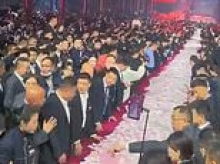 Thanks boss! Chinese company piles up $26million in bonus cash at end of year party with employees staggering off with as much as they can carry