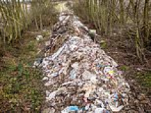 Professional fly-tippers dump 100ft river of rubbish near busy dual carriageway- which will cost £20,000 to clear up