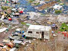 Travellers leave behind 'war zone': Litter, dirty nappies and burn-out caravan left behind after council evicted them from illegal site