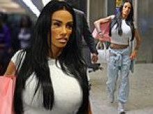 Katie Price finally returns to the UK to face her family - but her husband Lee Andrews remains in Dubai following 'travel ban' as he continues to insist they are planning on having a baby