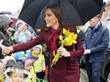 William and Kate are showered with daffodils as crowds brave the rain to see them on visit to Wales ahead of St David's Day