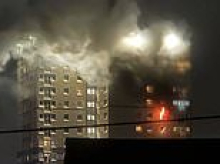 Man dies falling from window during tower block fire