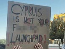 Protesters march through Cyprus to demand British bases be shut down as German frigate arrives at the port of Limassol