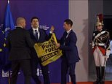 Moment rattled Emmanuel Macron is confronted by activists who storm stage during nuclear summit