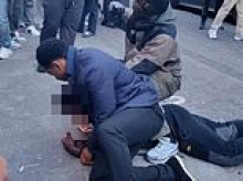 Moment teenage 'shoplifter' is pinned to the road in Mayfair by security guards seconds after 'stealing shoes from nearby shop'