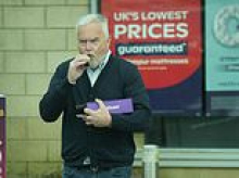 Huw Edwards breaks cover for first time since TV drama as disgraced former BBC broadcaster spotted puffing on vape after trip to the shops