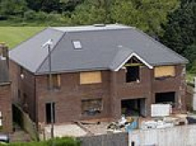 Neighbours' fury as 'unneighbourly and overbearing' newbuild six-bed mansion still has not been demolished despite homeowner being ordered to get rid of it TWICE