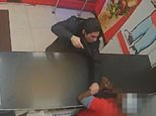 Moment thug threatens to kill chicken shop worker with a fake gun after row broke out over garlic sauce