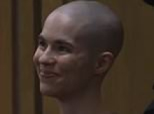 Shaven-headed woman smiles and makes VERY honest remark as she is jailed for murdering her father
