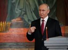 Moment Putin strolls into Easter Sunday service in Moscow - as Elon Musk's father watches on - after 'breaking Kremlin-declared ceasefire'