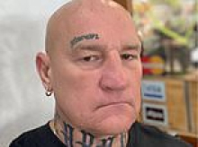 Two alleged assassins are accused of turning a Saturday morning at a Melbourne cafe into war zone by gunning down an underworld figure and fleeing across the border in a chauffer-driven Audi