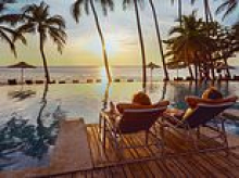 Flight prices are soaring but package holidays are more than £100 cheaper than last year as Brits told to book now