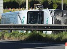 Four people rushed to hospital after ambulance flips on its side in crash with car and lorry