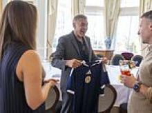 From Ocean's Eleven to Clarke's XI: George Clooney beams at Scotland football strip gift during charity trip